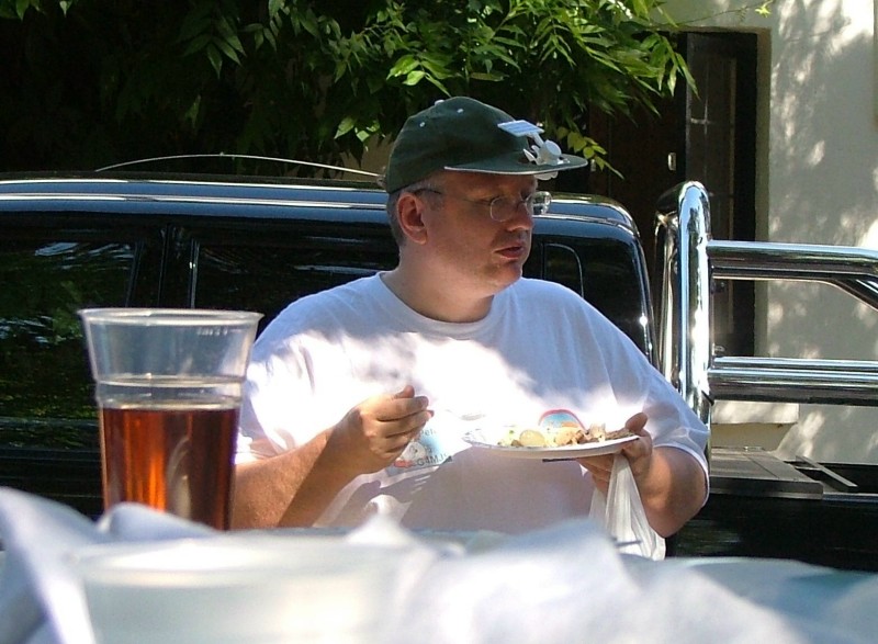 ../Images/Peter, G4MJS enjoying the roasted pig.jpg